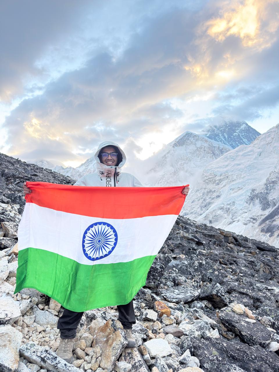 Soumya holding the Indian flag in the Himalayas