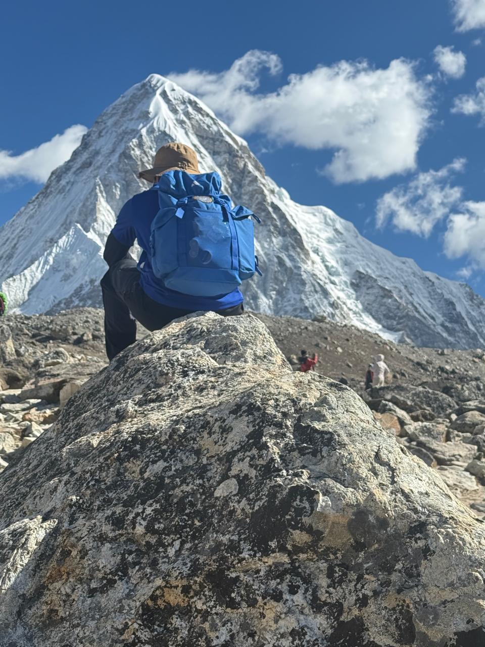 Soumya resting on a mountain ridge