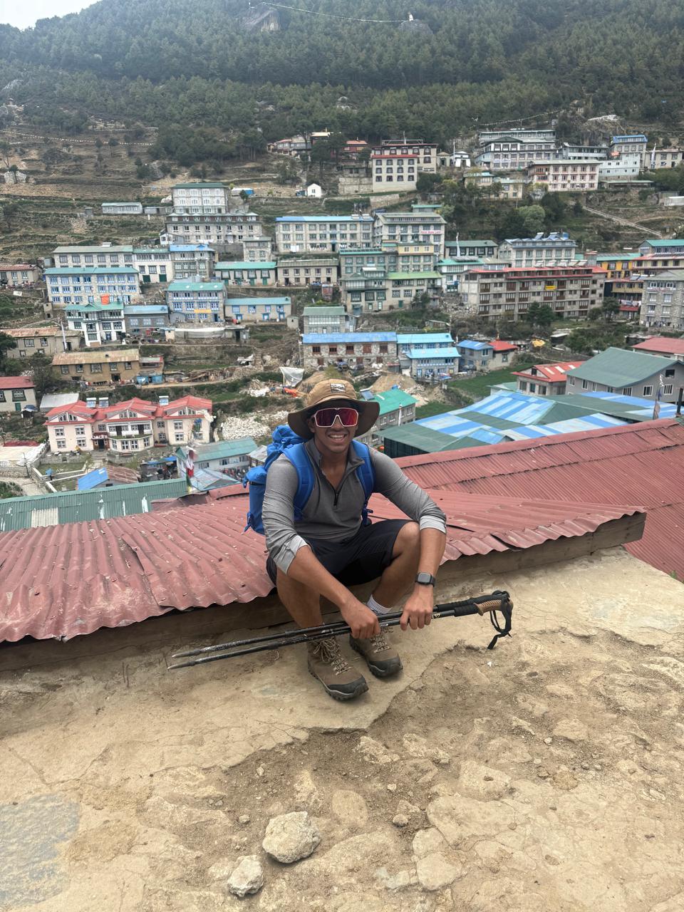Soumya overlooking a mountain settlement