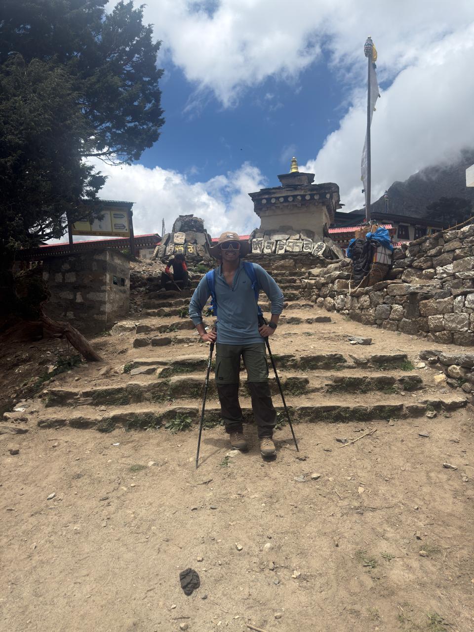 Soumya on the trail near a mountain temple